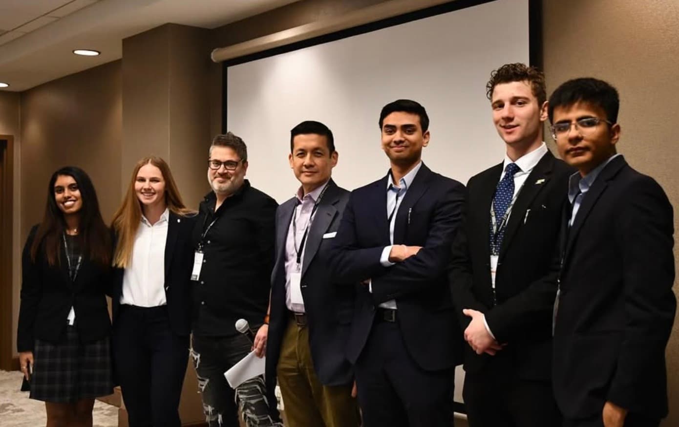Founders and judges lined up in front of the stage screen