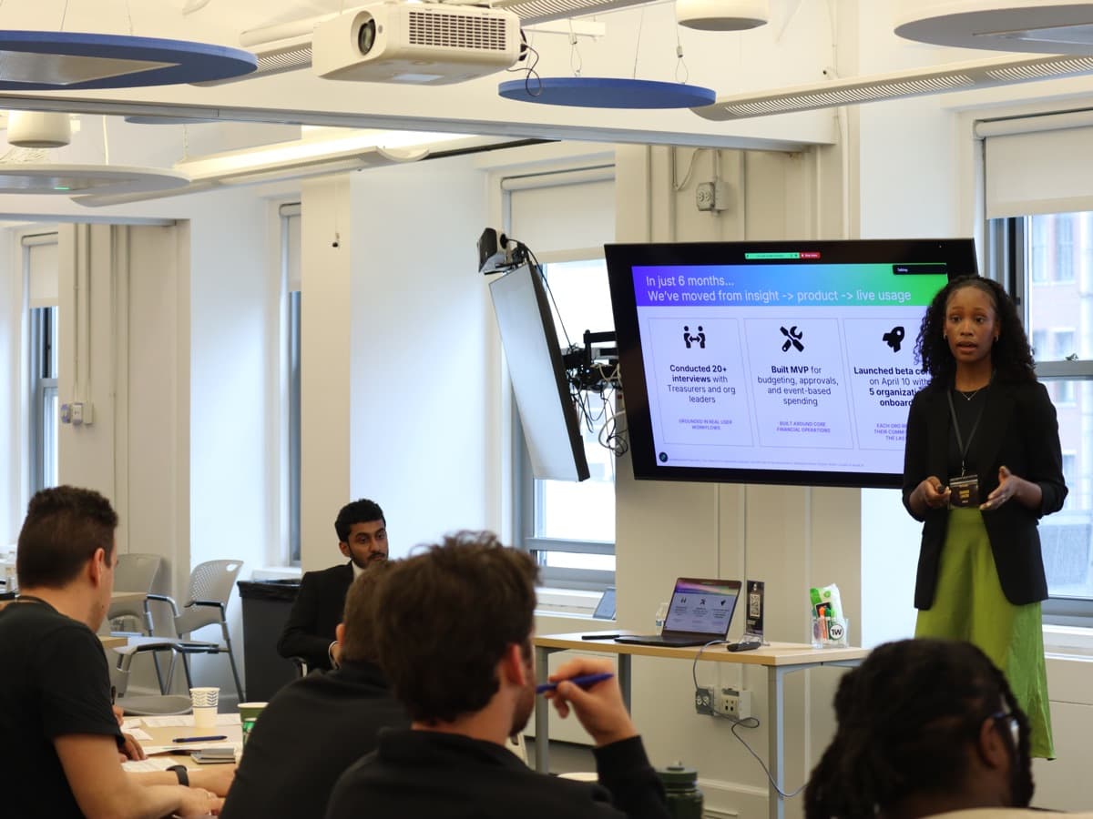A founder pitching in front of a screen